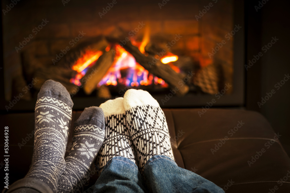 Feet warming by fireplace - obrazy, fototapety, plakaty 