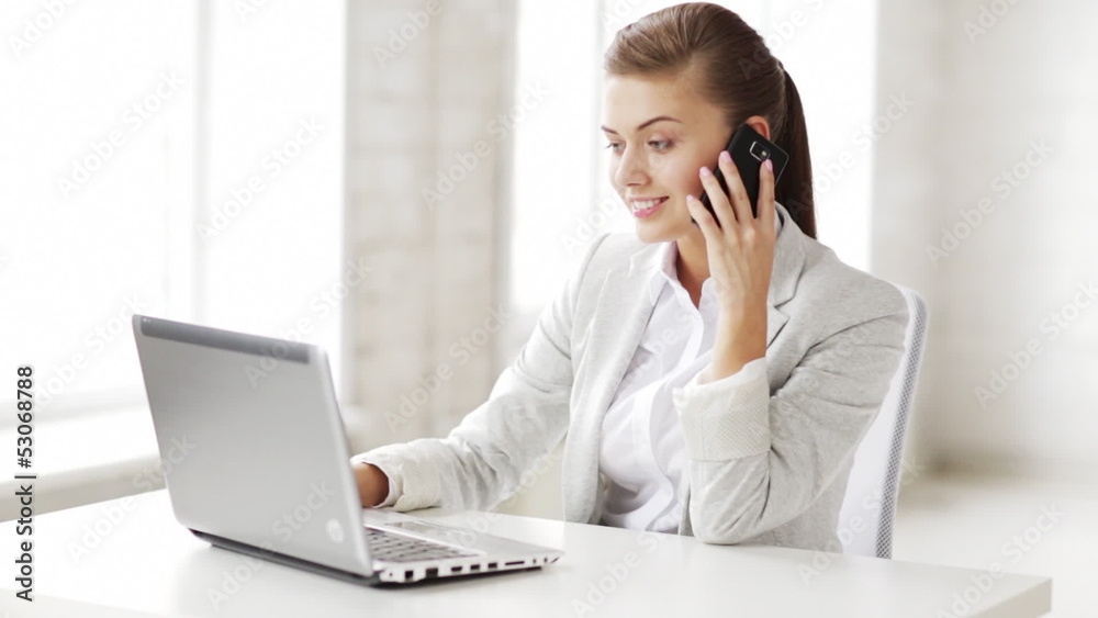 attractive office worker taking phone call attractive office worker taking phone call