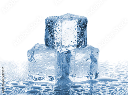 Three ice cubes with water drops