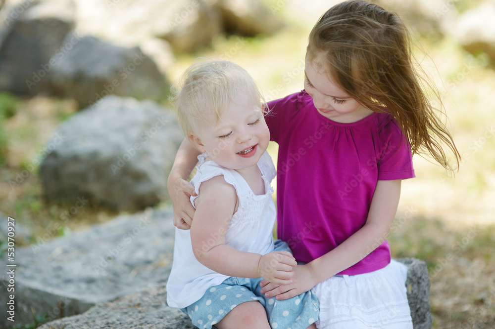 Fototapeta premium Portrait of two little sisters