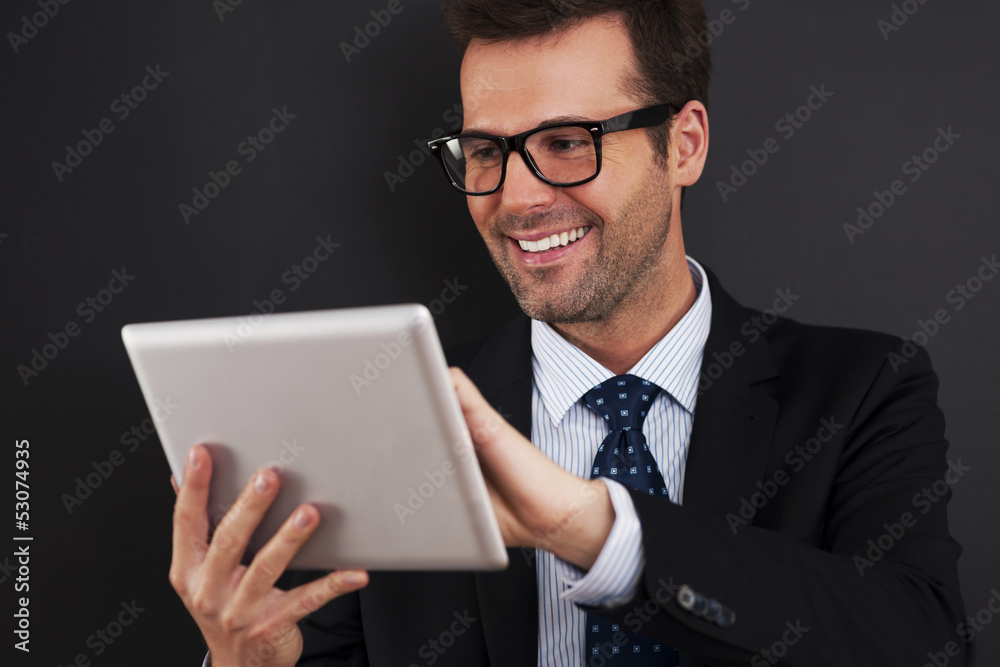 Businessman working on his touchpad Businessman working on his touchpad