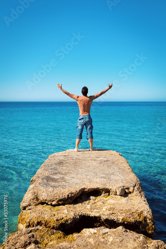Man with Arms Wide Open on Blue Tropical Sea