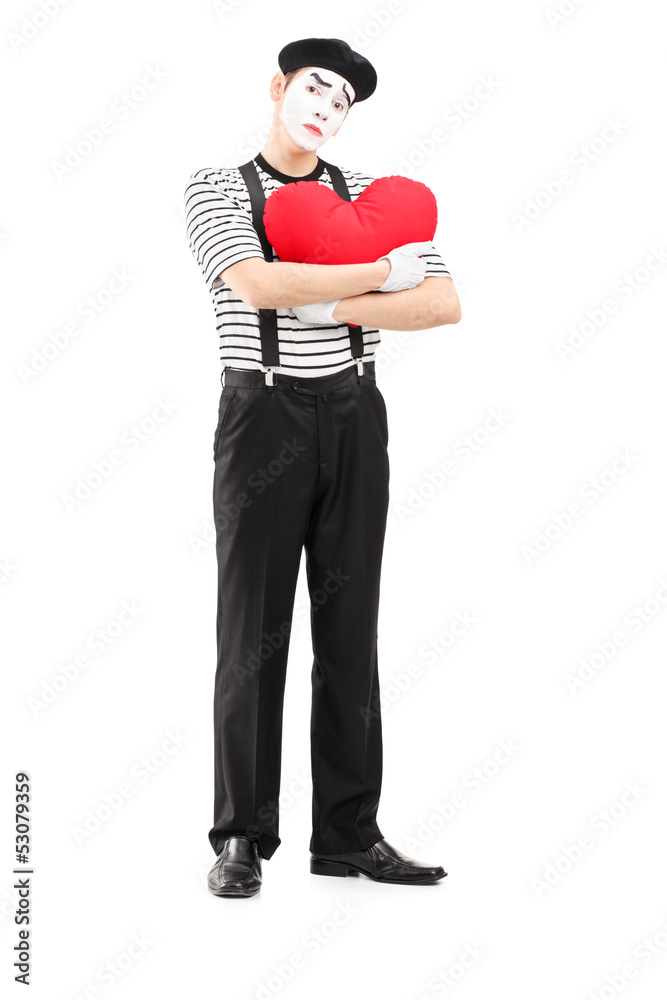 Full length portrait of a sad mime artist holding a red heart Full length portrait of a sad mime artist holding a red heart