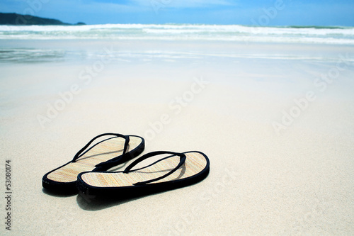 Flip flops on the sand on paradise beach