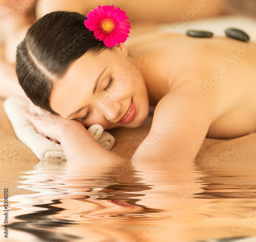 woman in spa with hot stones