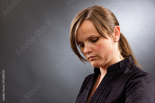 Portrait of a sad business woman looking down photo