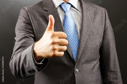 Closeup of a businessman  showing thumb up