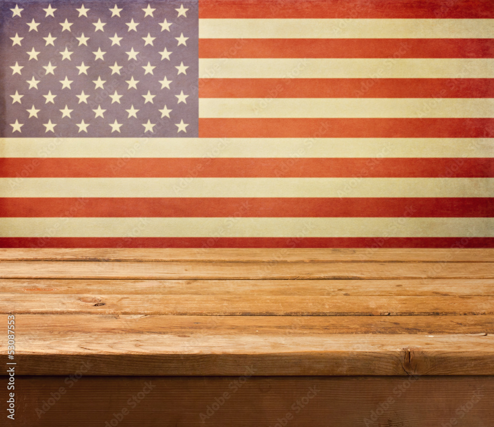 Fototapeta premium Empty wooden deck table over USA flag background