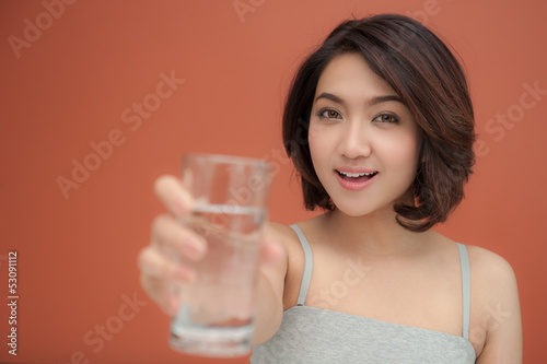 young woman holding glass of drinking water