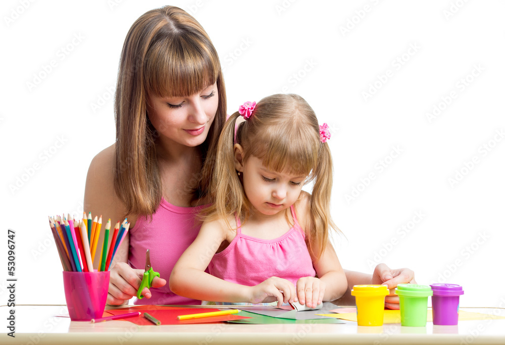 Mother and kid girl draw and cut together Mother and kid girl draw and cut together