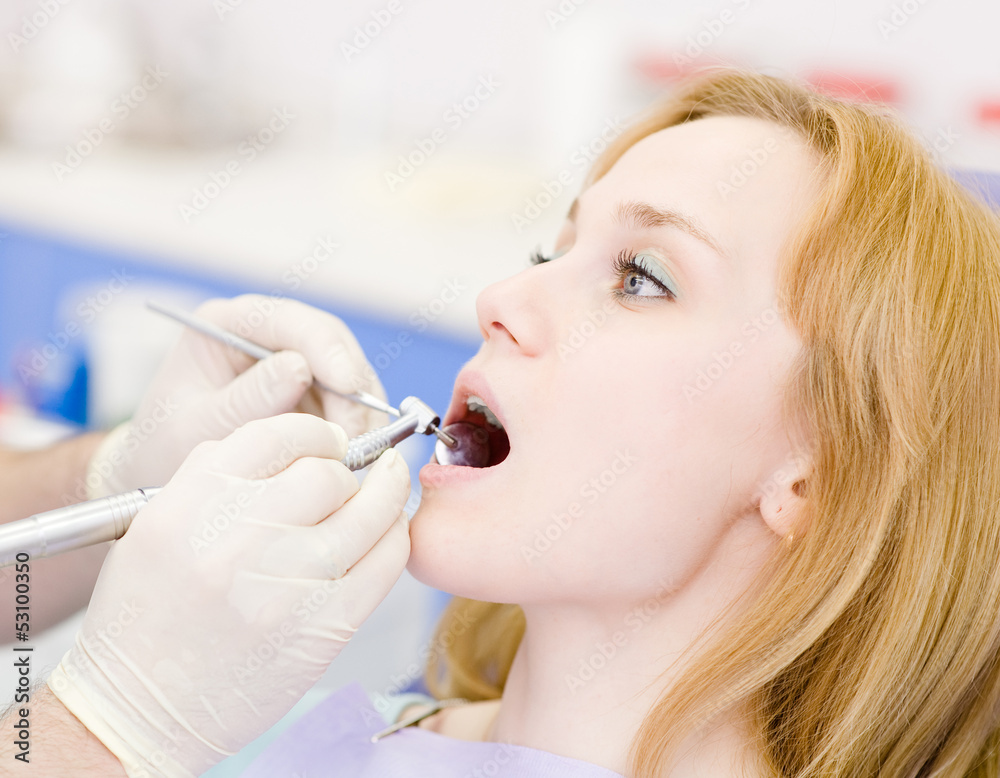 young woman with open mouth during drilling treatment young woman with open mouth during drilling treatment