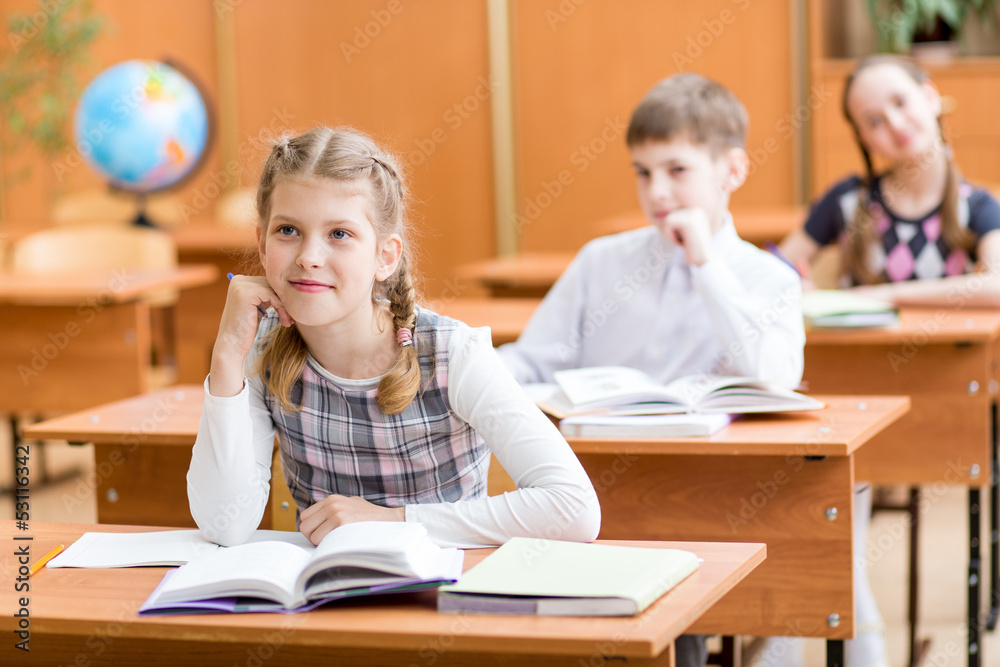 school children at lesson in classroom school children at lesson in classroom