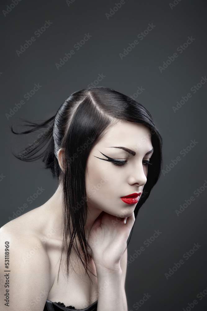Fototapeta premium Brunette woman with long straight hair on dark