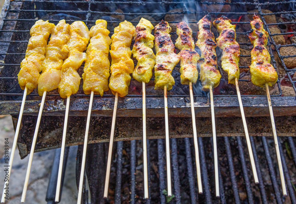 Chicken satay on the grill