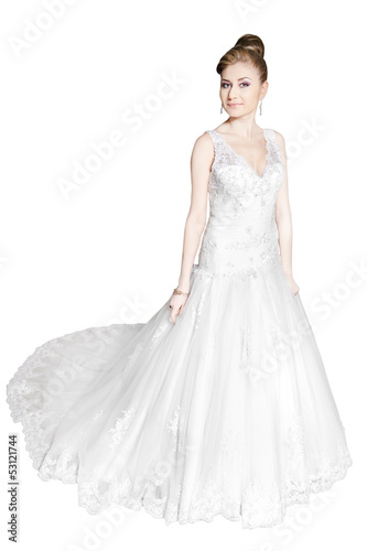 bride in white dress standing at full length on white