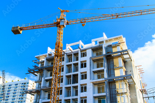 Apartments construction site with yellow crane