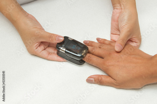 Patient with pulse oximeter on finger for monitoring
