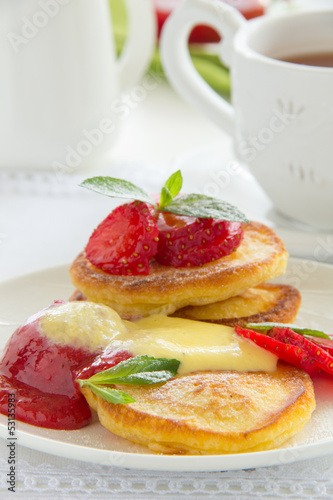 Pancakes with strawberries  strawberry sorbet and vanilla sauce.