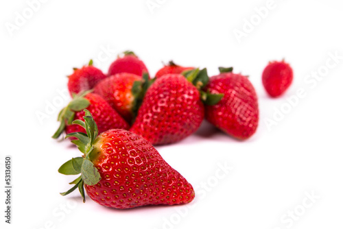 a group of several ripe red strawberries