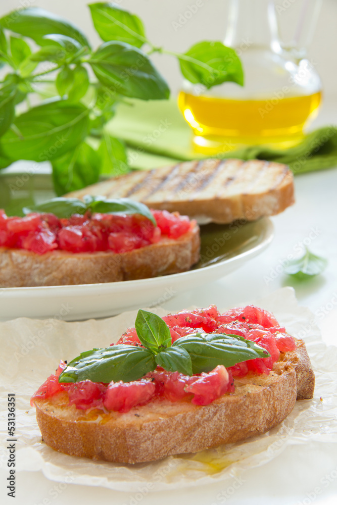 Bruschetta with tomato, basil and olive oil.