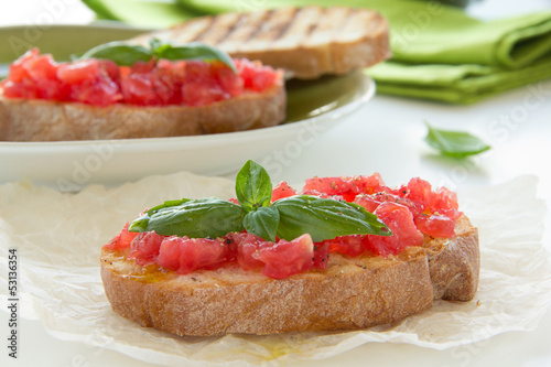 Bruschetta with tomato, basil and olive oil.