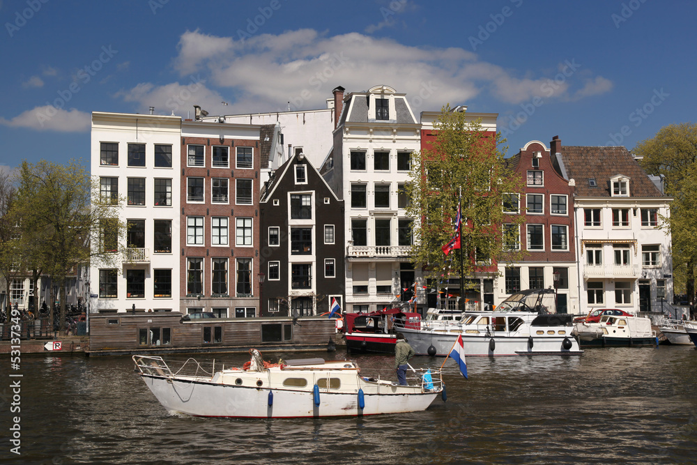 Amsterdam with motor boat on canal in Holland