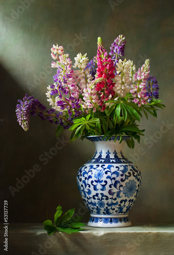 Still life with flowers lupine in a chinese vase