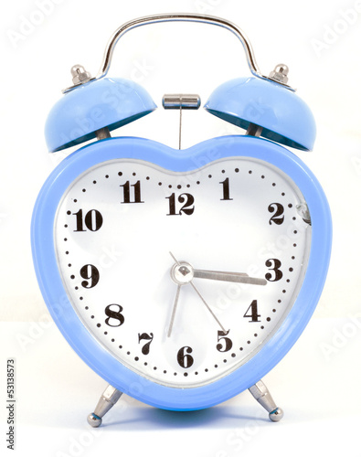 heart shaped blue alarm clock on white