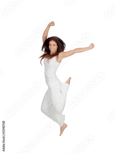 Attractive brunette girl dressed in white jumping