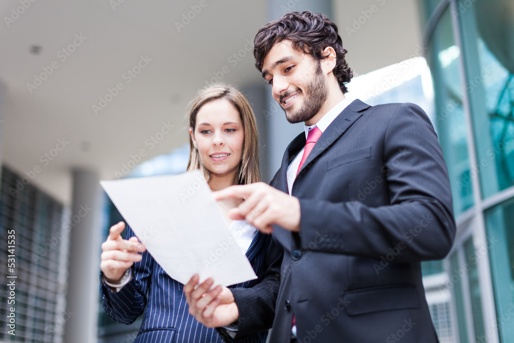 Business people reading a document Business people reading a document