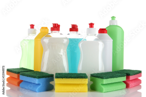 Bottles of dishwashing liquid and colorful sponges, isolated