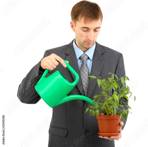 Young businessman watering ...