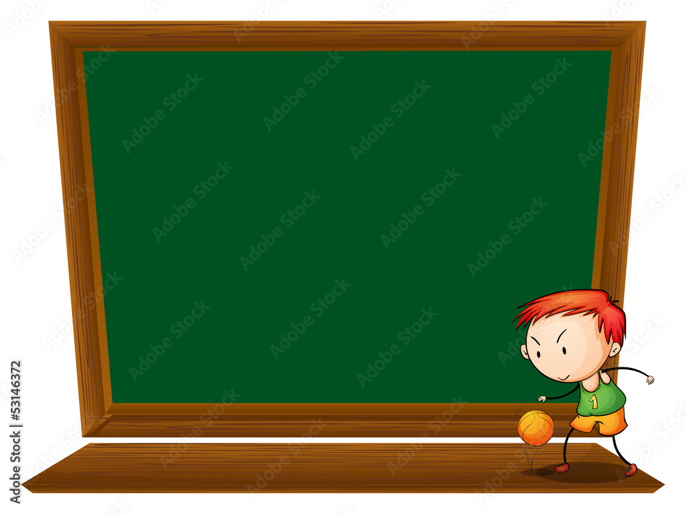 A boy playing basketball in front of the empty blackboard