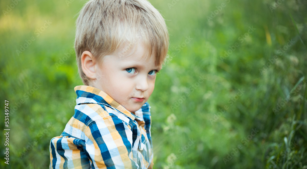 A cute little baby boy sit in the grass A cute little baby boy sit in the grass