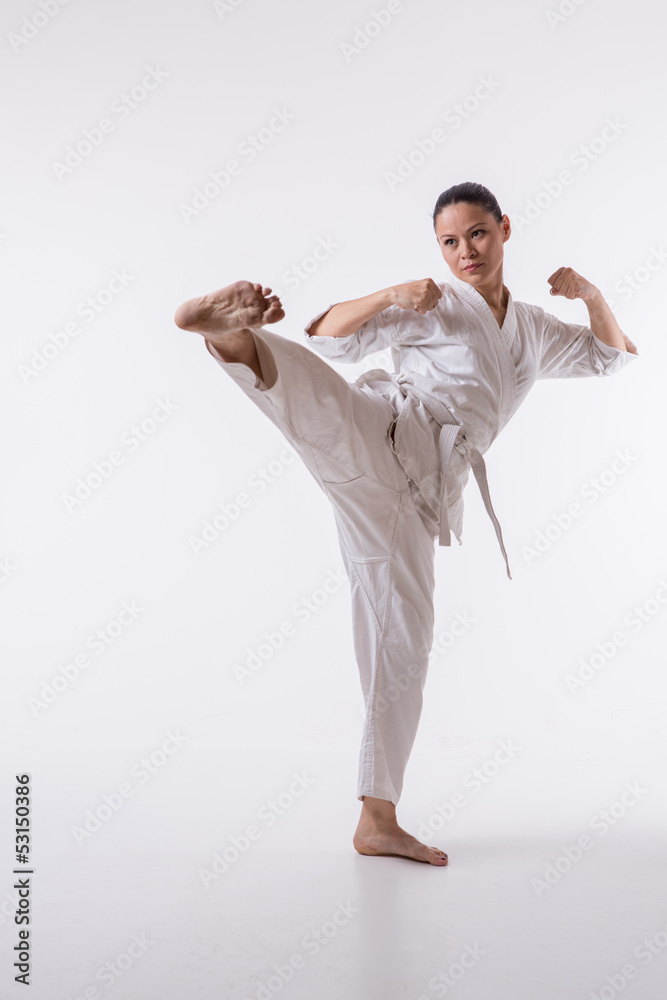 Beautiful woman in kimono show marshal art foot kick on white Beautiful woman in kimono show marshal art foot kick on white