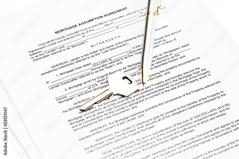 Mortgage assumption agreement with a pen for signature and a key Mortgage assumption agreement with a pen for signature and a key