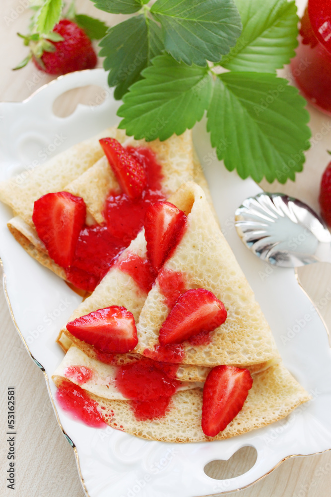 Fried pancakes with strawberries