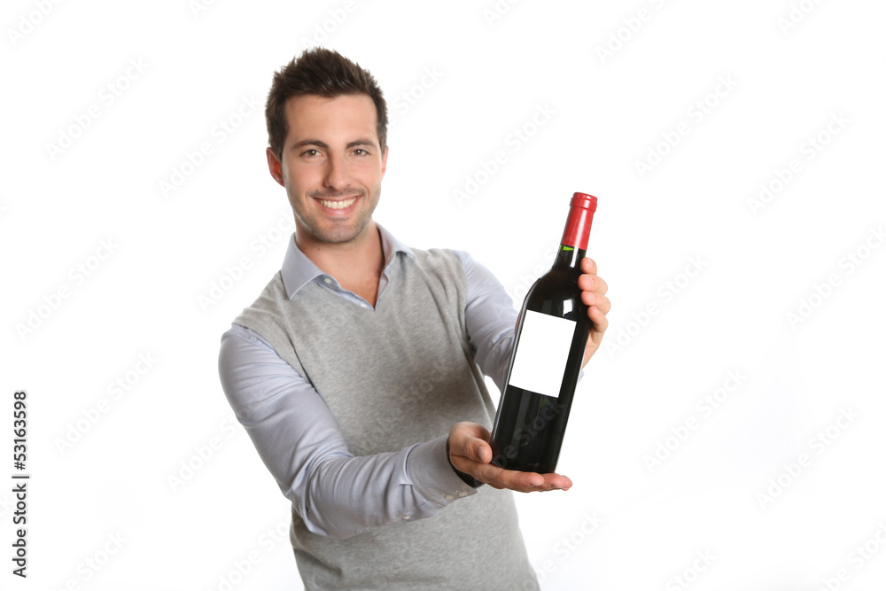 Happy winegrower showing wine bottle to camera Happy winegrower showing wine bottle to camera