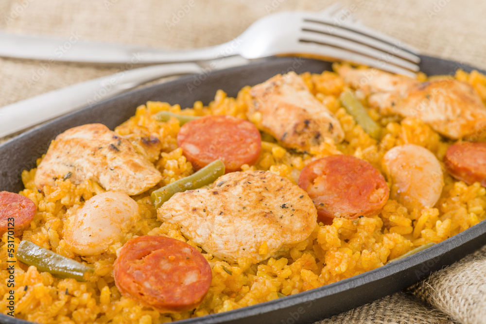 Paella Valenciana - Paella with chicken, sausage and vegetables Paella Valenciana - Paella with chicken, sausage and vegetables