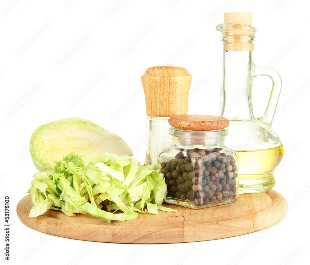 Green cabbage, oil, spices on cutting board, isolated on white Green cabbage, oil, spices on cutting board, isolated on white