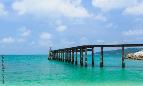 Wooden footbridge over the water near the beach