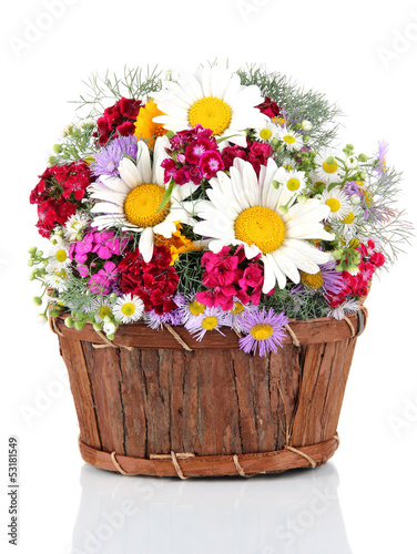 Beautiful bright flowers in wooden basket isolated on white