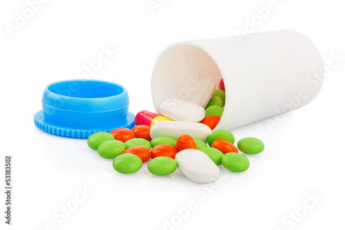 Pills spilling out of pill plastic bottle isolated on white,