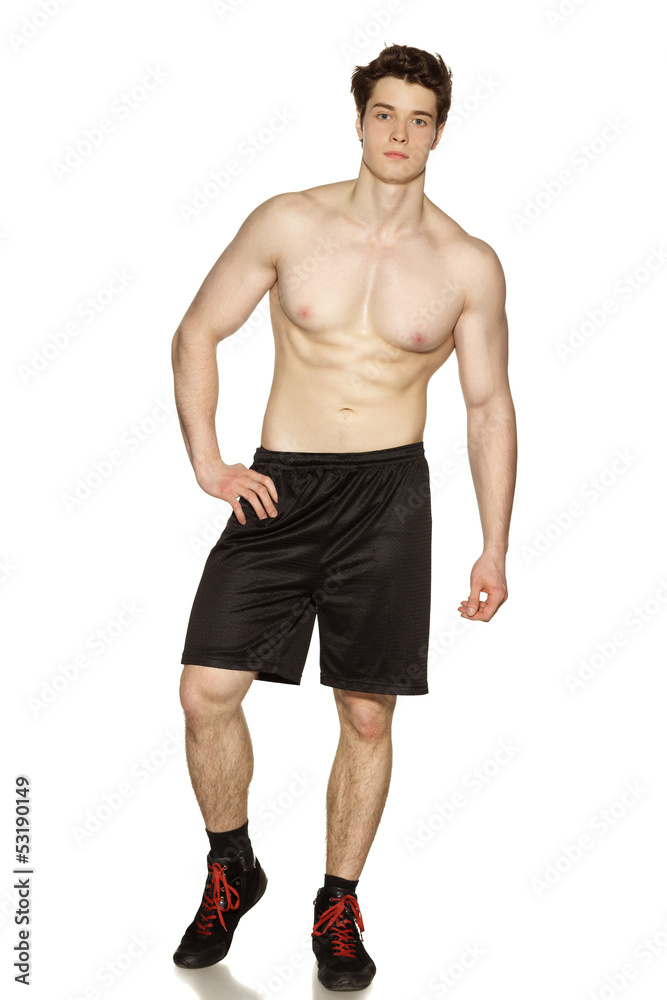 Handsome young muscular sports man on white background