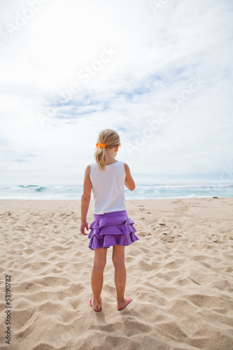 Young girl standing at beach