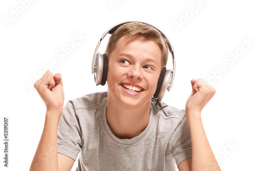 Smiling teenage boy listening to music