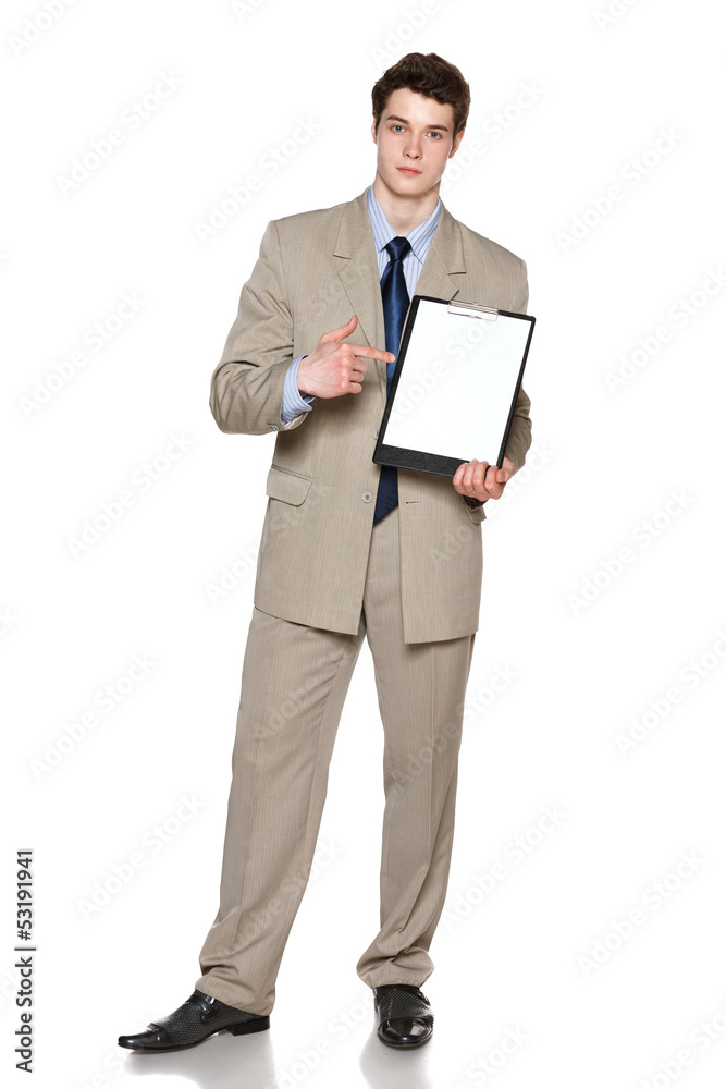 Serious businessman holding blank whiteboard, pointing at it Serious businessman holding blank whiteboard, pointing at it