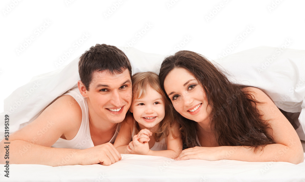 Happy family, mother, father and daughter resting on the white b Happy family, mother, father and daughter resting on the white b