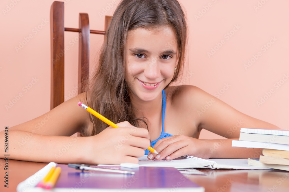 Hispanic girl studying at home and smiling Hispanic girl studying at home and smiling