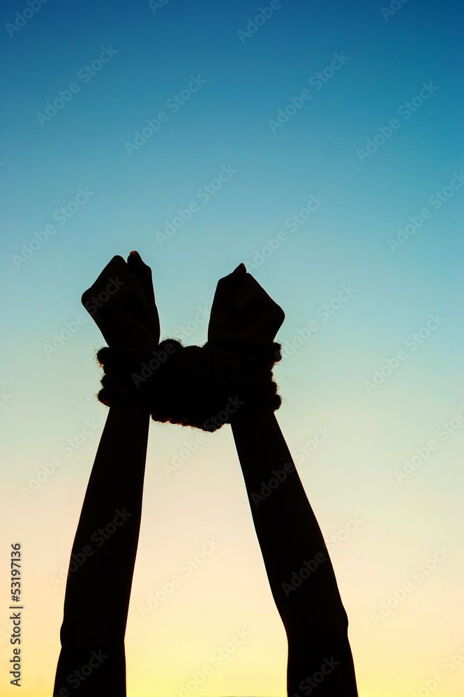 Hands tied up with rope